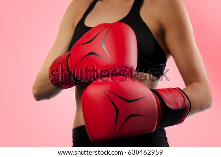 female boxer, closeup on red boxing gloves