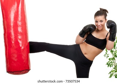 Female Boxer Kicking Punching Bag At Home