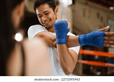 the female boxer and the male boxer standing stretching hand on chin look up for warm up - Powered by Shutterstock