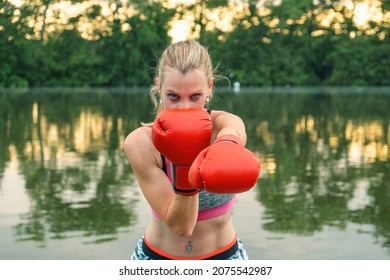 Female Boxer Portrait Workout On The Lake Water At Sunset