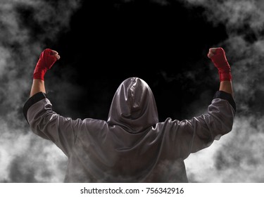 Female boxer with red boxing wraps wins the fight and bacame a champion. Victory pose. Black background with copy space. - Powered by Shutterstock