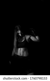 Female Boxer Training In The Dark Ring. Silhouette. Boxing Concept. Fighter Woman Fist Close Up. Sexy Girl With Perfect Body In Boxing Gloves At Gym. Concept Of Health And Sport.