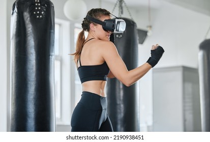 Female Boxer Using VR Goggles To Train, Exercise And Stay Fit And Healthy In A Modern Fitness Gym. Sporty, Exercising And Wellness Expert Or Fighter Training Using A 3d Virtual Reality Metaverse