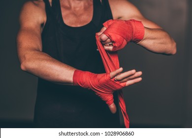 Female boxer wrapping up her hands get ready for boxing. - Powered by Shutterstock