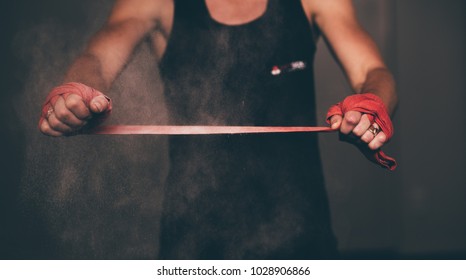 Female boxer wrapping up her hands with powder get ready for boxing. - Powered by Shutterstock