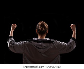 Female In Boxing Robe And Red Boxing Glove On Black Background.