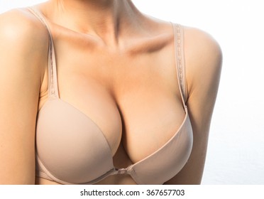 Female breast in a beige bra