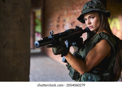 Female British Special Forces Soldier With Weapon Take Part In Military Maneuver. War, Army, Technology And People Concept. Lady In Military Gear In Abandoned Building Alone, In Position