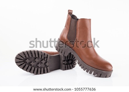 Female brown leather boot on white background, isolated product, comfortable footwear.