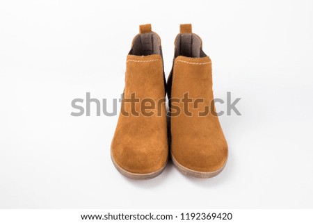 Female brown leather boot on white background.