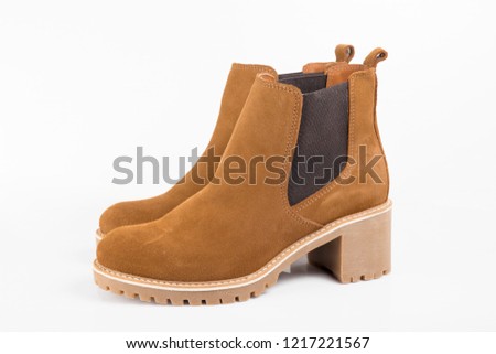 Female brown leather boot on white background, isolated product, comfortable footwear.