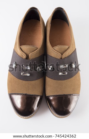 Female brown leather shoe on white background, isolated product, comfortable footwear, top view.