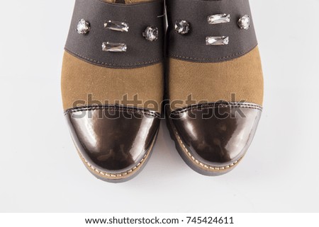 Female brown leather shoe on white background, isolated product, comfortable footwear, top view.