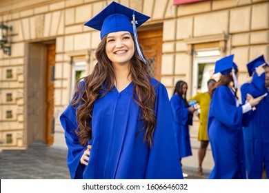 Female Brunette Latino College Or High School Graduate Smiling Confidently Wearing  Blue Cap And Gown At Graduation