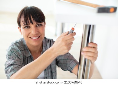 A Female Builder Fixing The Table