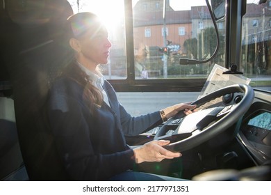 Female Bus Driver Driving A Bus