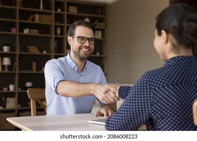 Female business leader, employer hiring happy candidate after successful interview, giving handshake. Business professional and client shaking hands in office, closing deal, negotiations, meeting