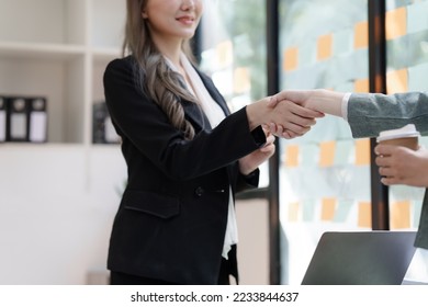 Female business worker with colleagues in Thailand working together at office desk, getting shaking hands, successful and agreement concept - Shutterstock ID 2233844637