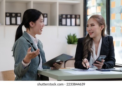 Female business worker with colleagues in Thailand working together at office desk, Female office worker business suit working with document file and paper work. - Shutterstock ID 2233844639