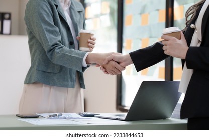 Female business worker with colleagues in Thailand working together at office desk, getting shaking hands, successful and agreement concept - Shutterstock ID 2233844653