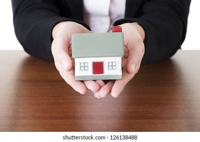 Female businesswoman hands holding house. Home protecting concept for insurance or security - Shutterstock ID 126138488