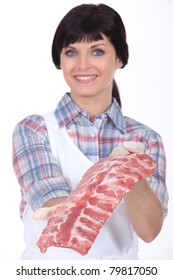 Female Butcher Holding A Rack Of Ribs