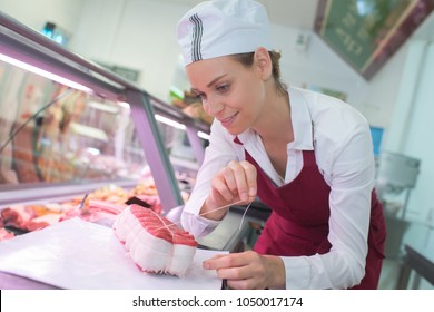 Female Butcher In A Supermarket