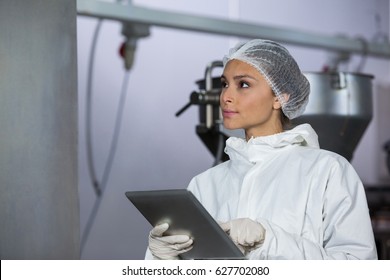 Female butcher using digital tablet at meat factory - Powered by Shutterstock