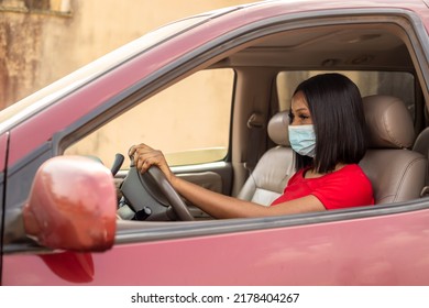 Female Cab Driver Wearing A Red T-shite Holding Steering Wheel With Nose Mask On Road Trip Concept