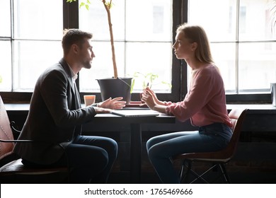 Female cafe owner talk with customer, hr manager and applicant at restaurant position talking during job interview formal meeting indoor. Colleagues during lunch break discuss common project execution