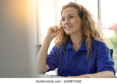 Female Caller Or Receptionist Phone Operator.Copy Space For Some Text, Advertising Or Slogan. Call Center Service. Photo Of Customer Support Or Sales Agent.  Help Line Answering And Telemarketing.