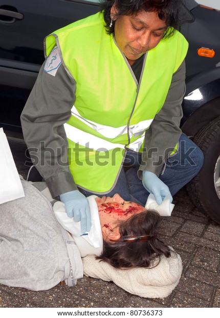 Female car crash victim\
with whiplash neck brace (the sleeve badges were replaced by a non\
existing logo)
