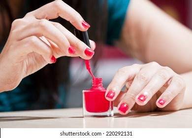 Female Carefully Painting Her Fingernails.