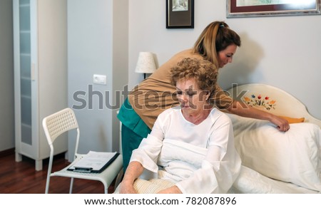 Similar – Caregiver accommodating  pillow to elderly female patient