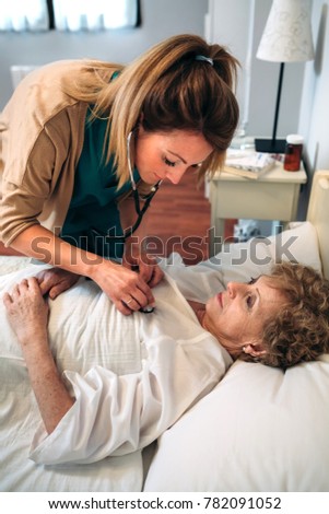 Similar – Caregiver auscultating senior woman