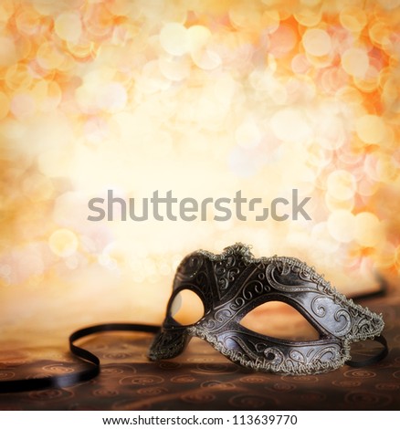 female carnival mask with golden background