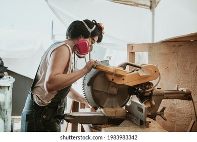 Female carpenter using a compound miter saw - Powered by Shutterstock