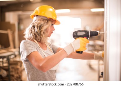 Female Carpenter Using Screwdriver