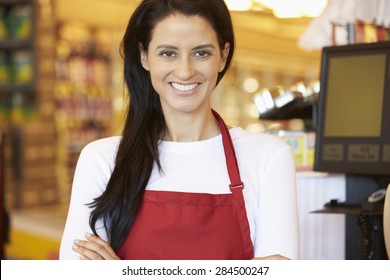 Female Cashier At Supermarket Checkout