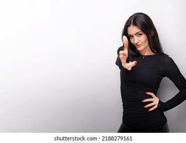 Female In Casual Clothes Pointing Finger Pistol To Camera, Threatening To Shoot