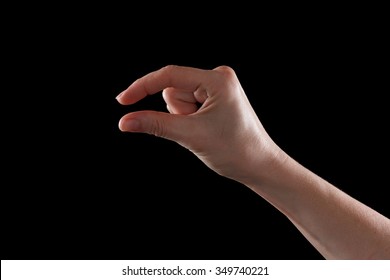 Female Caucasian Hand Gesturing A Small Amount, Isolated On Black.