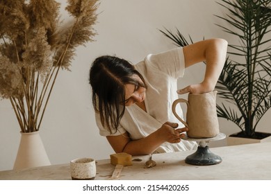 Female ceramist hands sculpt clay dishes - Powered by Shutterstock