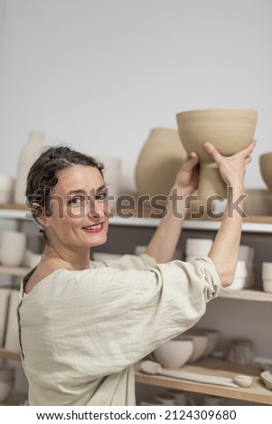 Similar – Beautiful ceramist owner looking to the camera while smiling