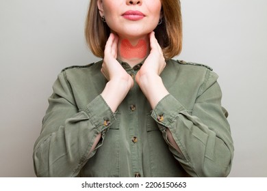 Female checking thyroid gland by herself. Thyroid disorder includes goiter, hyperthyroid, hypothyroid, tumor or cancer. Health care - Shutterstock ID 2206150663