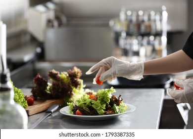 Female chef cooking tasty food in restaurant kitchen, closeup - Shutterstock ID 1793387335
