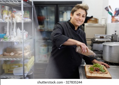 A Female Chef Drizzling Balsamic Vinegar On An Open Sandwich