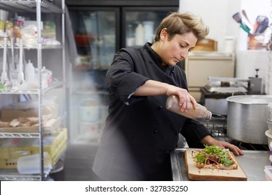 A Female Chef Drizzling Balsamic Vinegar On An Open Sandwich