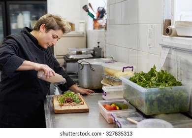 A Female Chef Drizzling Balsamic Vinegar On An Open Sandwich