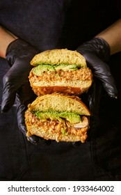 Female Chef Holding A Cut Vegan Burger