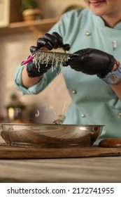 Female Chef Prepares Italian Pasta With Tomatoes And Permesan In A Bright Kitchen In A Rustic Style. Mint Coat Apron. Chef At Home